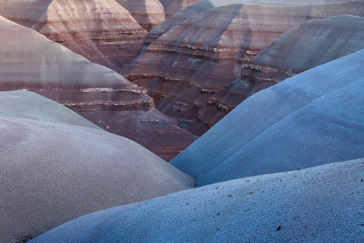 Aerial view of layered rock formations reveal earthy hues contrasting with cool blues a geological tapestry woven across the landscape Hanksville Utah United States. Aerial view of layered rock formations reveal earthy hues contrasting with cool blues a geological tapestry woven across the landscape Hanksville Utah United States.