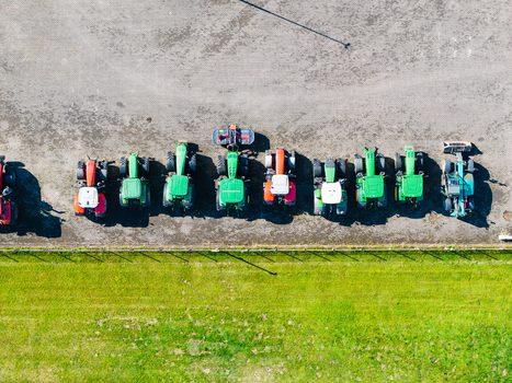 Aerial view of a row of various colorful tractors parked at a farm equipment supplier in Kekava Kekava Municipality Latvia. Aerial view of a row of various colorful tractors parked at a farm equipment supplier in Kekava Kekava Municipality Latvia.