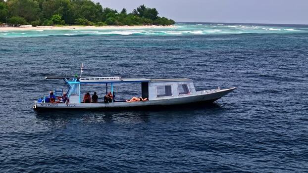 Aerial view of boat with passengers in the sea near Bali Indonesia.