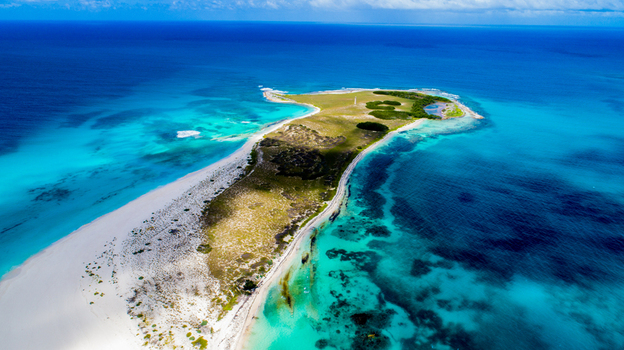 Aerial view of Los Roques archipelago with white sand beaches turquoise Caribbean waters and lush vegetation Los Roques Dependencias Federales Venezuela. Aerial view of Los Roques archipelago with white sand beaches turquoise Caribbean waters and lush vegetation Los Roques Dependencias Federales Venezuela.