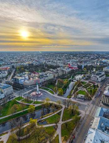 Aerial view of the Freedom Monument surrounded by Bastejkalna Park the city canal and historic urban architecture during golden hour in Riga Latvia. Aerial view of the Freedom Monument surrounded by Bastejkalna Park the city canal and historic urban architecture during golden hour in Riga Latvia.