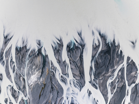 Aerial view of glacial streams carve intricate patterns across the stark landscape a dance of white against the dark earth Lake Tekapo Canterbury Region New Zealand. Aerial view of glacial streams carve intricate patterns across the stark landscape a dance of white against the dark earth Lake Tekapo Canterbury Region New Zealand.