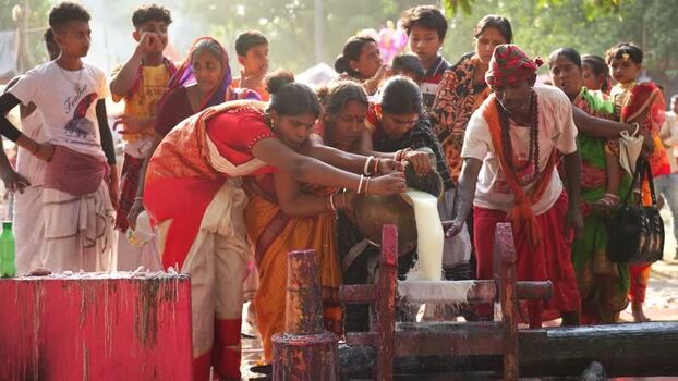View of people performing a traditional milk pouring ritual Bangladesh. View of people performing a traditional milk pouring ritual Bangladesh.