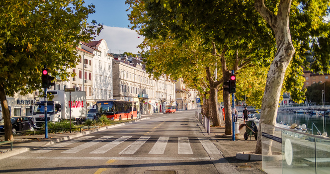 Rijeka Croatia 19 September 2026 View of a street in Rijeka with a bus traffic lights and trees along the waterfront. Rijeka Croatia 19 September 2026 View of a street in Rijeka with a bus traffic lights and trees along the waterfront.