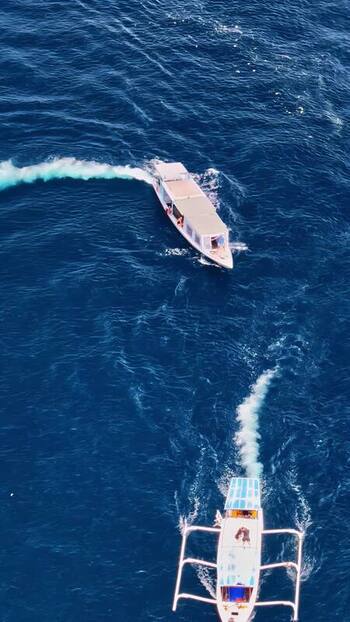 Aerial view of boats sailing on blue ocean waters Indonesia.
