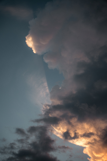 View of dramatic storm clouds illuminated by golden hour sunlight in the sky over Costa Rica.