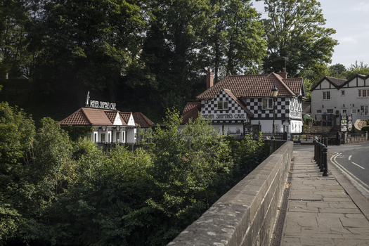 Knaresborough England United Kingdom 14 July 2026 View of Mother Shipton s Cave with its distinctive black and white timber framed architecture surrounded by lush trees and foliage.