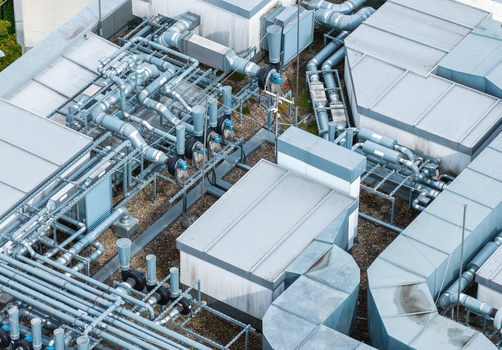 Aerial view of the complex HVAC ventilation system and industrial piping on the flat roof of the Poznan University of Technology Warta Campus in Poznan Greater Poland Voivod Poland. Aerial view of the complex HVAC ventilation system and industrial piping on the flat roof of the Poznan University of Technology Warta Campus in Poznan Greater Poland Voivod Poland.