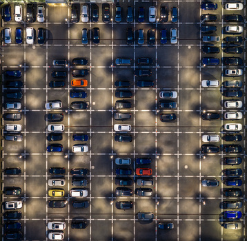 Aerial view of Audi Zentrum Berlin Adlershof parking lot with numerous cars parked in marked spaces showing organized rows and asphalt surface in Berlin Berlin Germany.