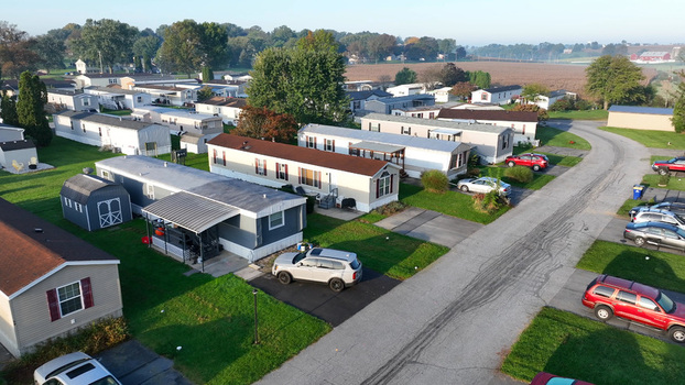 Aerial view of the Manheim housing development featuring rows of mobile homes paved streets parked cars and green lawns in Manheim Pennsylvania United States. Aerial view of the Manheim housing development featuring rows of mobile homes paved streets parked cars and green lawns in Manheim Pennsylvania United States.