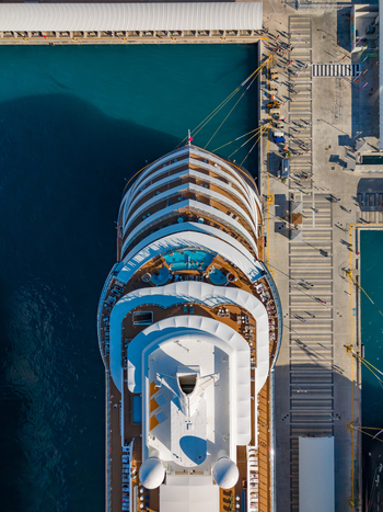 Aerial view of a large cruise ship docked at the Nassau Cruise Port with turquoise water and port infrastructure in Nassau The Bahamas. Aerial view of a large cruise ship docked at the Nassau Cruise Port with turquoise water and port infrastructure in Nassau The Bahamas.