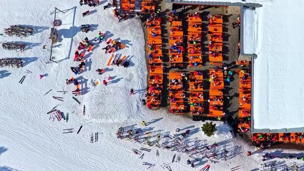 Aerial view of ski resort terrace with orange tables Austria.