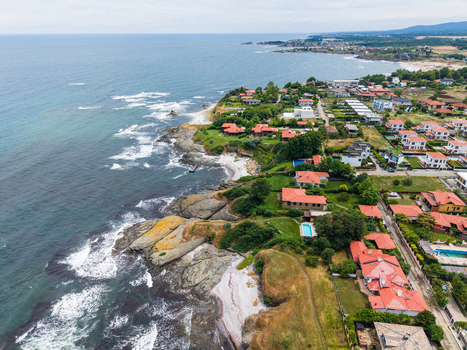 Aerial view of the coastal town with red roofed houses rocky shoreline and the Black Sea in Lozenets Burgas Bulgaria.