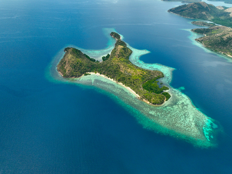 Aerial view of CYC Beach on a tropical island surrounded by vibrant turquoise coral reefs and deep blue ocean waters in Coron Mimaropa Philippines. Aerial view of CYC Beach on a tropical island surrounded by vibrant turquoise coral reefs and deep blue ocean waters in Coron Mimaropa Philippines.