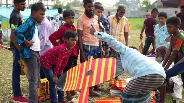 View of people and children with large colorful kites Bangladesh. View of people and children with large colorful kites Bangladesh.