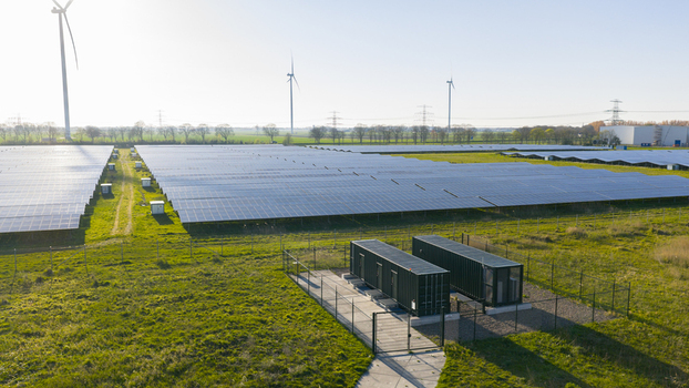 Aerial view of Solar park Delfzijl featuring rows of photovoltaic panels and wind turbines under a clear sky in Farmsum Groningen Netherlands. Aerial view of Solar park Delfzijl featuring rows of photovoltaic panels and wind turbines under a clear sky in Farmsum Groningen Netherlands.