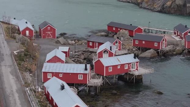 Aerial view of traditional red rorbuer cabins in Lofoten Norway.