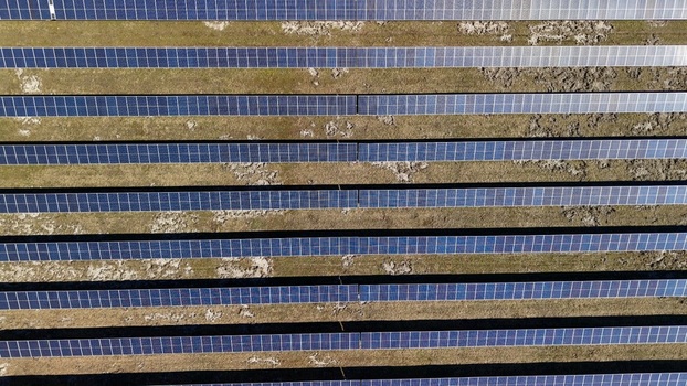 Aerial view of endless rows of solar panels stretching across the landscape reflecting the sky Elkton Florida United States. Aerial view of endless rows of solar panels stretching across the landscape reflecting the sky Elkton Florida United States.