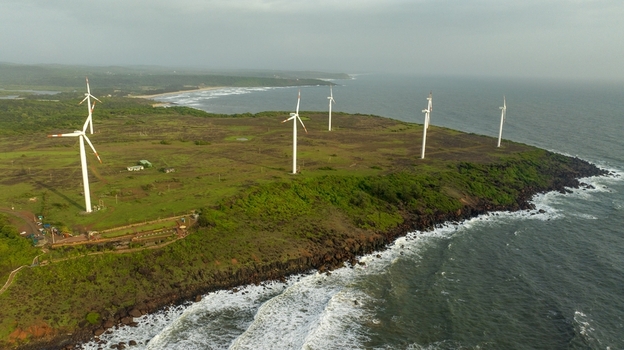 Aerial view of Devgad Windmills standing on the green coastal cliffs overlooking the Arabian Sea in Devgad Maharashtra India. Aerial view of Devgad Windmills standing on the green coastal cliffs overlooking the Arabian Sea in Devgad Maharashtra India.