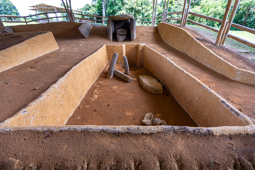 View of ancient stone structures and earthen burial pits at San Agustin Archaeological Park in San Agustin Huila Colombia.