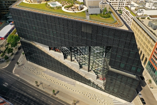 Aerial view of the Axel Springer Neubau featuring its modern dark facade glass atrium and green rooftop terrace in Berlin Berlin Germany. Aerial view of the Axel Springer Neubau featuring its modern dark facade glass atrium and green rooftop terrace in Berlin Berlin Germany.