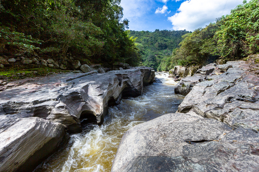 View of Estrecho del Rio Magdalena featuring a narrow river channel eroded rock formations and lush green vegetation San Agustin Huila Colombia.