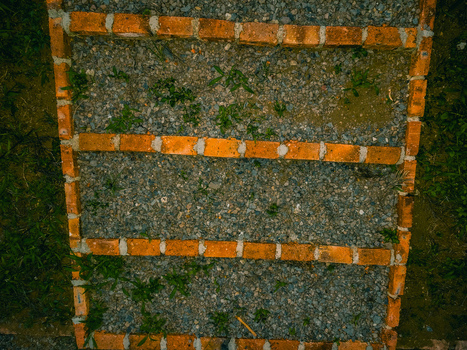 Aerial view of Goalpara Tea Park featuring a gravel path with brick borders and steps surrounded by lush green grass in Kecamatan Sukaraja Jawa Barat Indonesia. Aerial view of Goalpara Tea Park featuring a gravel path with brick borders and steps surrounded by lush green grass in Kecamatan Sukaraja Jawa Barat Indonesia.