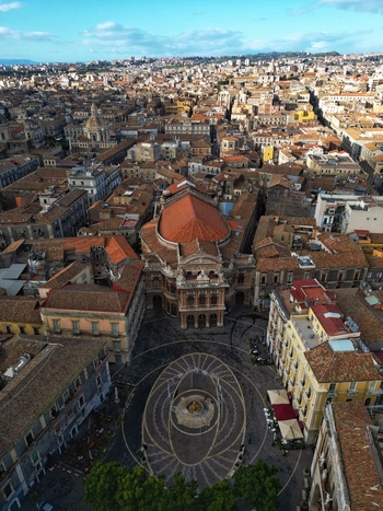 Aerial view of Teatro Massimo Bellini and the circular pavement of Piazza Vincenzo Bellini surrounded by historic rooftops in Catania Sicily Italy. Aerial view of Teatro Massimo Bellini and the circular pavement of Piazza Vincenzo Bellini surrounded by historic rooftops in Catania Sicily Italy.