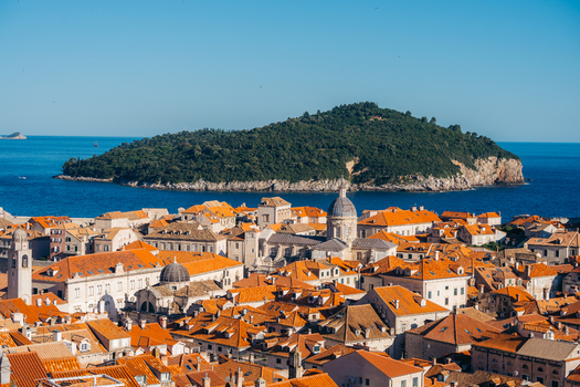 View of Dubrovnik Old Town with its iconic orange rooftops and historic cathedral dome overlooking the Adriatic Sea and Lokrum Island Dubrovnik Dubrovnik Neretva County Croatia. View of Dubrovnik Old Town with its iconic orange rooftops and historic cathedral dome overlooking the Adriatic Sea and Lokrum Island Dubrovnik Dubrovnik Neretva County Croatia.