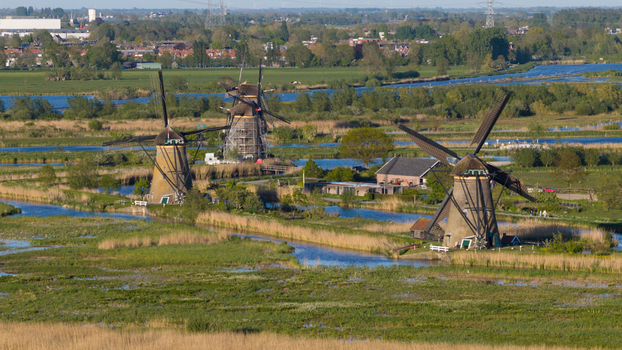 Aerial view of the historic windmills and water canals of the polder landscape in Kinderdijk South Holland Netherlands. Aerial view of the historic windmills and water canals of the polder landscape in Kinderdijk South Holland Netherlands.