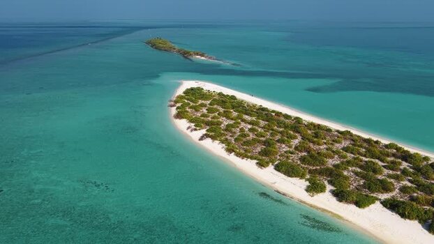 Aerial view of a tropical island and turquoise water Maldives.
