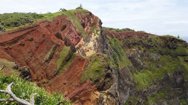 View of a rugged cliff face overlooking the ocean Pitcairn Islands.
