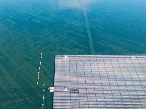 Aerial view of the floating solar farm on Cottbuser Ostsee a former open pit mine showing solar panels on water with repair works in progress in Cottbus Brandenburg Germany. Aerial view of the floating solar farm on Cottbuser Ostsee a former open pit mine showing solar panels on water with repair works in progress in Cottbus Brandenburg Germany.