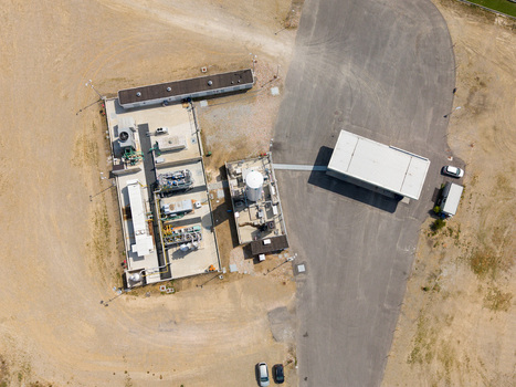 Aerial view of a modern biomethane production facility with bioCNG and bioLNG fueling station featuring industrial equipment and storage tanks in Tavazzano con Villavesco Lombardy Italy.