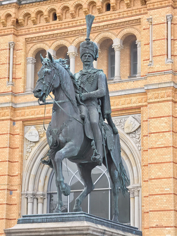 Hanover Germany 29 March 2026 View of the Ernst August monument a bronze equestrian statue of King Ernst August I set against the ornate yellow brick facade of the station.