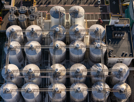 Aerial view of the beer industrial complex with rows of large metal storage tanks and connecting catwalks in Santo Domingo Dominican Republic. Aerial view of the beer industrial complex with rows of large metal storage tanks and connecting catwalks in Santo Domingo Dominican Republic.