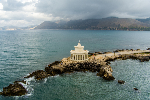 Aerial view of Saint Theodore Lighthouse on a rocky peninsula surrounded by the Ionian Sea in Argostoli Greece.