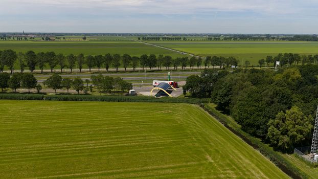 Middenbeemster Netherlands 20 June 2026 Aerial view of Fastned Charging Station situated along a highway surrounded by lush green fields and tree lines in the rural landscape of Noord Holland. Middenbeemster Netherlands 20 June 2026 Aerial view of Fastned Charging Station situated along a highway surrounded by lush green fields and tree lines in the rural landscape of Noord Holland.