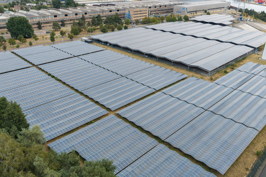 Aerial view of the solar power plant at Haven Genk with extensive rows of photovoltaic panels installed over a large industrial area in Genk Vlaanderen Belgium.