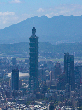 Aerial view of Taipei 101 skyscraper rising above the dense urban skyline of Taipei City Taiwan. Aerial view of Taipei 101 skyscraper rising above the dense urban skyline of Taipei City Taiwan.