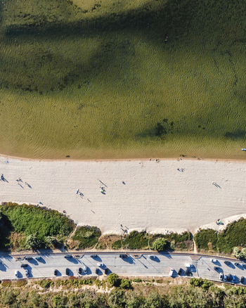 Aerial view of a beautiful beach along the lake side in Lagoa de Albufeira a beautiful lake near Lisbon in Sesimbra Municipality Setubal Portugal.