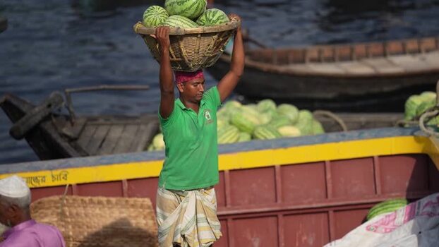 View of a man carrying watermelons at Sadarghat Bangladesh.