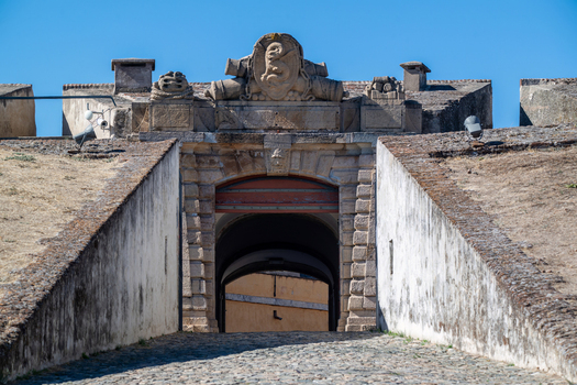 Elvas Portugal 10 September 2026 View of the historic stone entrance gate of Forte de Nossa Senhora da Graca featuring detailed masonry a carved coat of arms and a cobblestone path. Elvas Portugal 10 September 2026 View of the historic stone entrance gate of Forte de Nossa Senhora da Graca featuring detailed masonry a carved coat of arms and a cobblestone path.