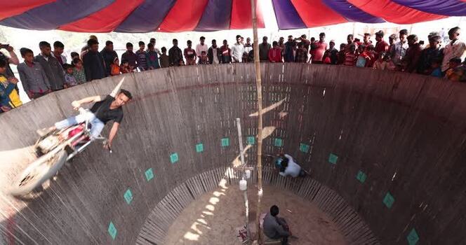 View of a motorcyclist performing in the Well of Death Bangladesh.