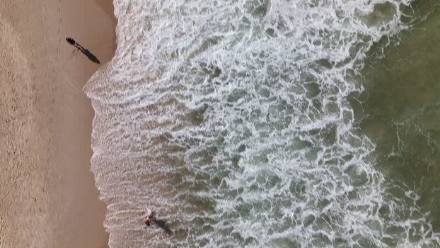 Aerial view of waves crashing on Copacabana Beach Brazil.