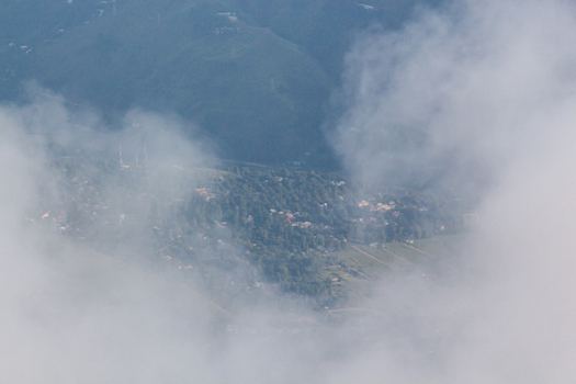 View of a village nestled among trees and hills veiled by ethereal clouds creating a dreamlike landscape Pir Chanasi Azad Kashmir Pakistan. View of a village nestled among trees and hills veiled by ethereal clouds creating a dreamlike landscape Pir Chanasi Azad Kashmir Pakistan.