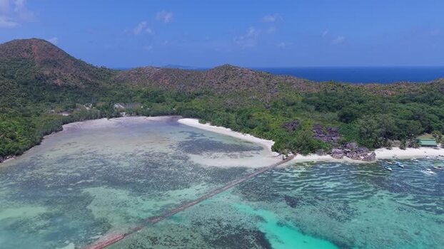 Aerial view of Curieuse island and turquoise waters Seychelles.