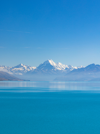 View of snow capped mountains reflected in the turquoise waters a serene landscape under a clear sky Lake Pukaki Mount Cook Lookout New Zealand. View of snow capped mountains reflected in the turquoise waters a serene landscape under a clear sky Lake Pukaki Mount Cook Lookout New Zealand.