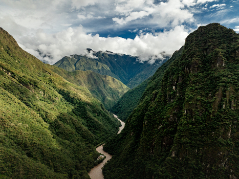 Aerial view of the Urubamba River winding through the lush green jungle landscape of the Andes mountains near Aguas Calientes Cusco Peru. Aerial view of the Urubamba River winding through the lush green jungle landscape of the Andes mountains near Aguas Calientes Cusco Peru.