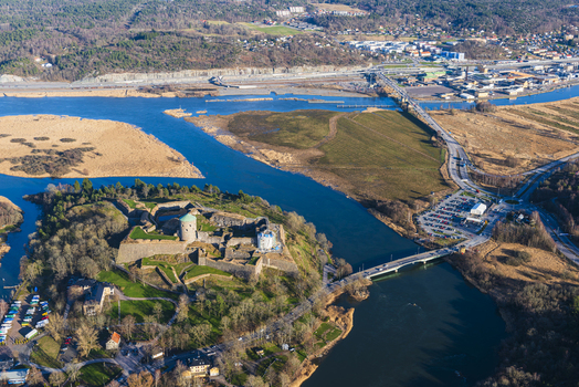 Aerial view of Bohus Fortress situated on a rocky outcrop surrounded by the river with nearby bridges roads and green landscape in Kungalv Vastra Gotalands lan Sweden. Aerial view of Bohus Fortress situated on a rocky outcrop surrounded by the river with nearby bridges roads and green landscape in Kungalv Vastra Gotalands lan Sweden.